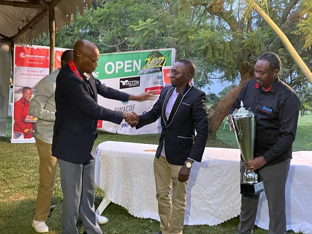 PMC amateur golf league champion James Muigai is congratulated as he prepares to receive the winnersu2019 trophy from Britamu2019s Chief Executive Officer Andrew Kulayige, (right). 