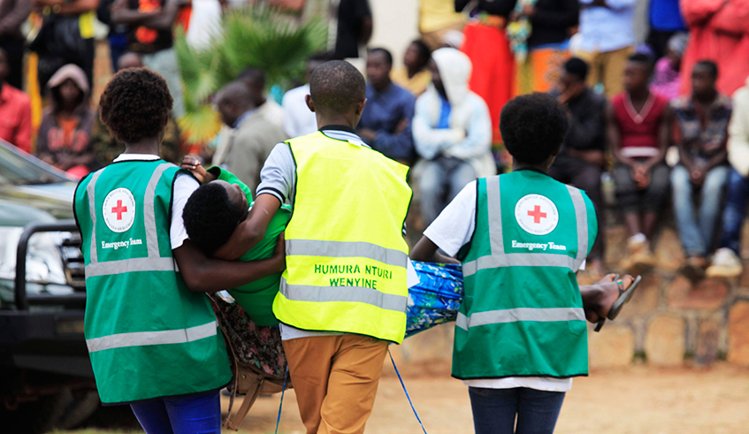 Red Cross volunteers carry a trauma victim during a commemoration event at Murambi Genocide Memorial . / File