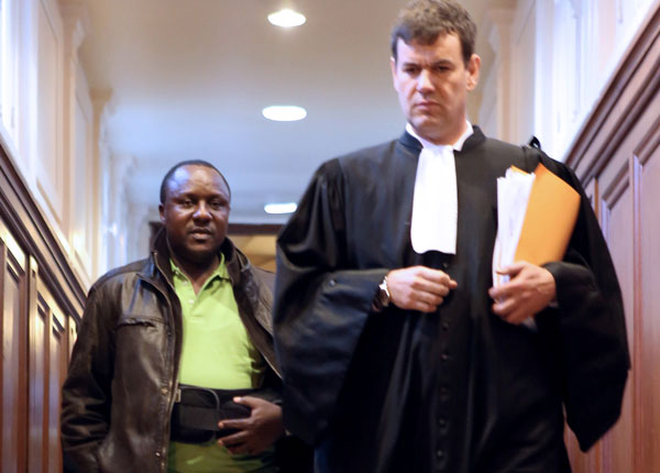 Genocide suspect Claude Muhayimana with his lawyer in France.