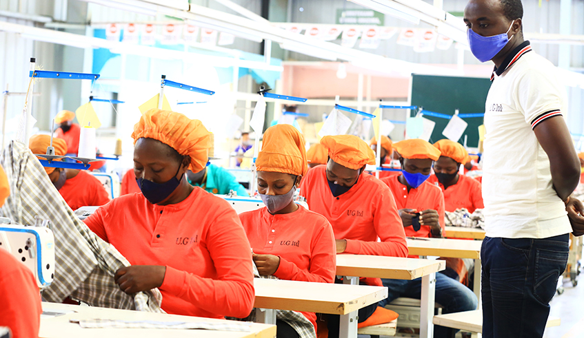 Workers at Ufaco Garments Ltd in the Kigali Special Economic Zone on June 22. According to the National Institute of Statistics of Rwanda, most economic activities have recovered to pre-Covid levels, except a few such as hotel and restaurants, administrative and support activities. / Photo: Sam Ngendahimana.