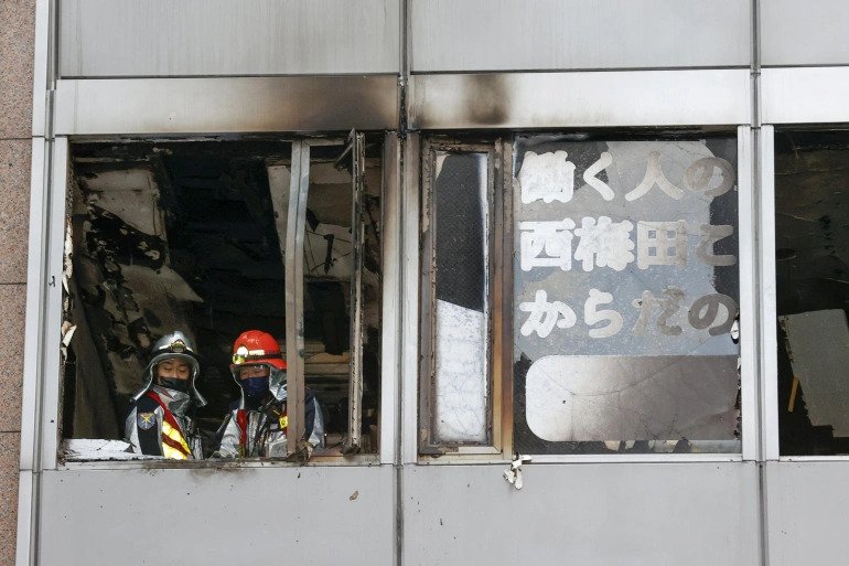 Firefighters are seen at a building where a fire broke out in Osaka, western Japan December 17, 2021 in this photo taken by Kyodo. 