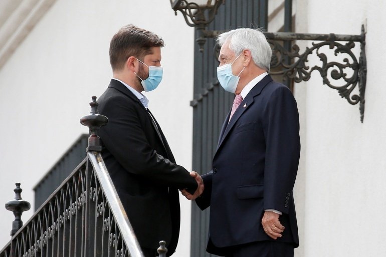 Chile's outgoing President Sebastian Pinera (R) and President-elect Gabriel Boric meet at the presidential palace La Moneda, Santiago, Chile, December 20, 2021. 