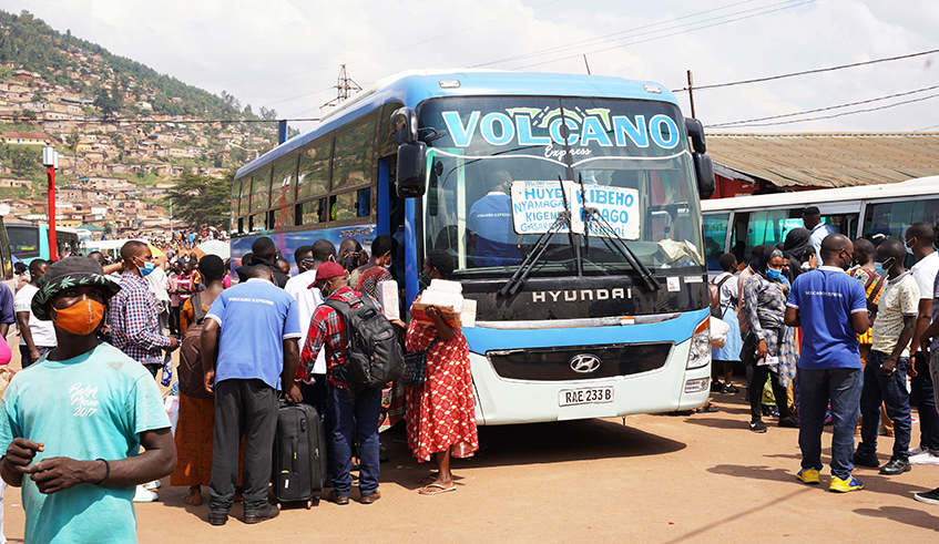 Commuters board buses at Nyabugogo Taxi Park as they head upcountry for festive seasons on Monday, December 20. / Photo: Craish Bahizi.