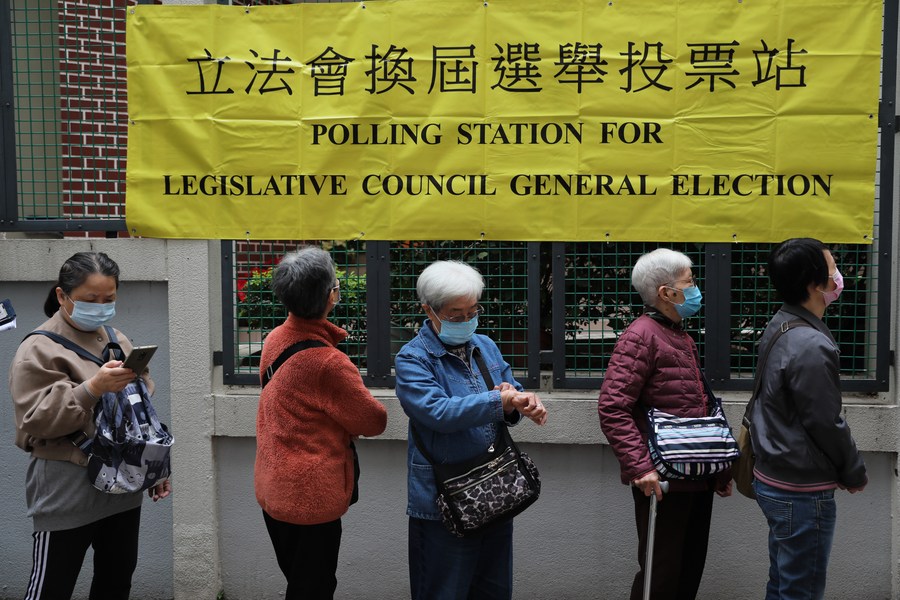 Voters wait to cast ballot at a polling station in Wan Chai of Hong Kong, south China, Dec. 19, 2021. / Xinhua/Wu Xiaochu