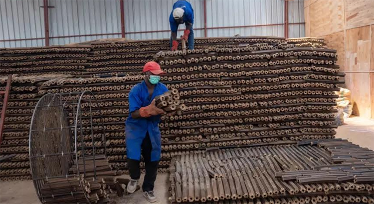 Workers sort briquette in the factory in Rwanda. / Courtesy