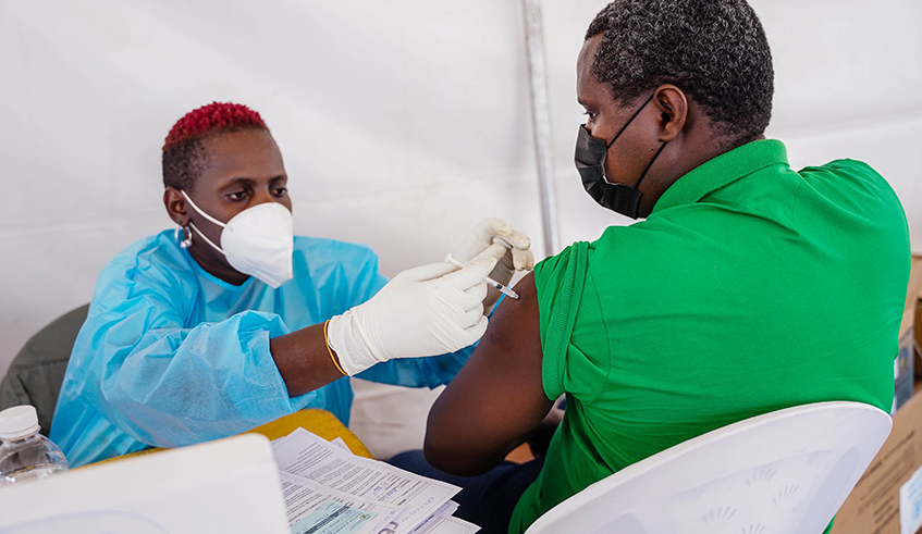 A health worker conducts the Covid19 vaccination exercise at Nyabugogo Taxi park on Dec 13.Kagame said that 80 per cent of Rwandans aged 12 and above have received at least one dose of Covid-19 vaccine. / Dan Nsengiyumva