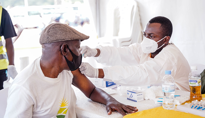 A resident recieves the covid19 jab at Nyabugogo Taxis Park on December 13, 2021.Early January 2022, over 5.5 million Rwandans had been fully vaccinated while above 7.7 M people had obtained their first dose . / Dan Nsengiyumva