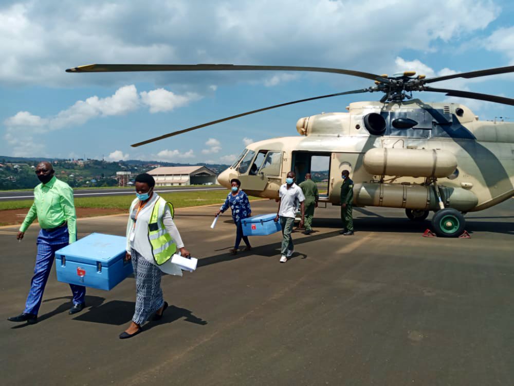 Medics offloading Covid-19 vaccines from a Rwanda Defence Force helicopter in May 2021 to be able to inoculate citizens from some of the remotest areas in the country. The participation and coordination between different public, private and civil society agencies have been credited for the effective roll out of vaccines in the country. / Photo: Courtesy.