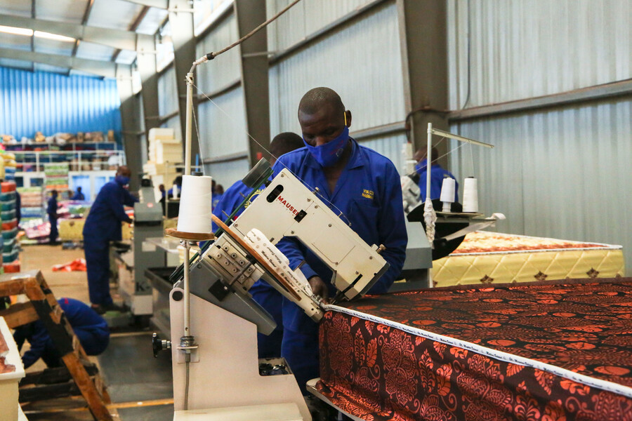 A worker sewing a mattress at Matelas Dodoma factory at Kigali Special Economic Zone. 