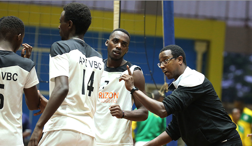 APR Volleyball team head coach Elia Mutabazi (L) gives instructions to his players during a past league game at Amahoro indoor stadium. / File