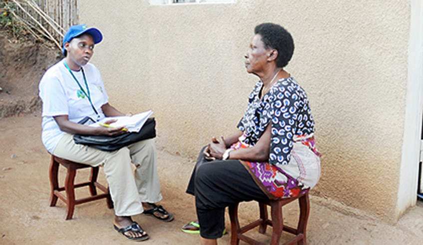 A volunteer collects data during the last general census in Rwanda . / File