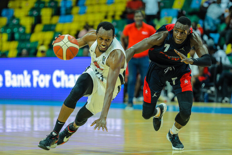 Patriots' Steven Hagumintwari tries to go past REG players during a league game. 