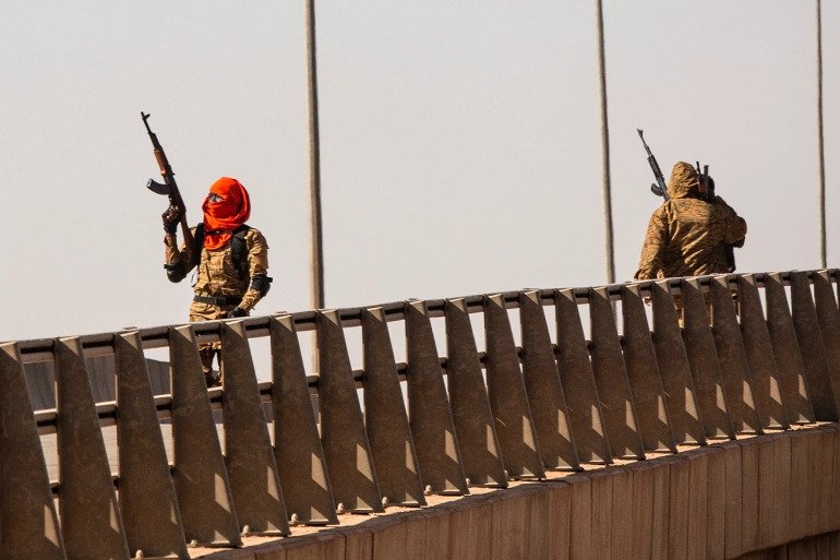 A soldier fires into the air near the Lamizana camp in Ouagadougou. A soldier fires into the air near the Lamizana camp in Ouagadougou.