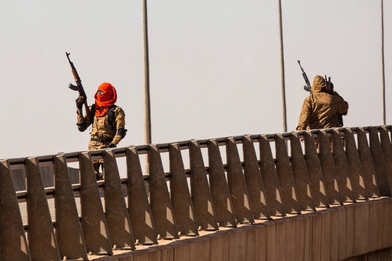 A soldier fires into the air near the Lamizana camp in Ouagadougou. 