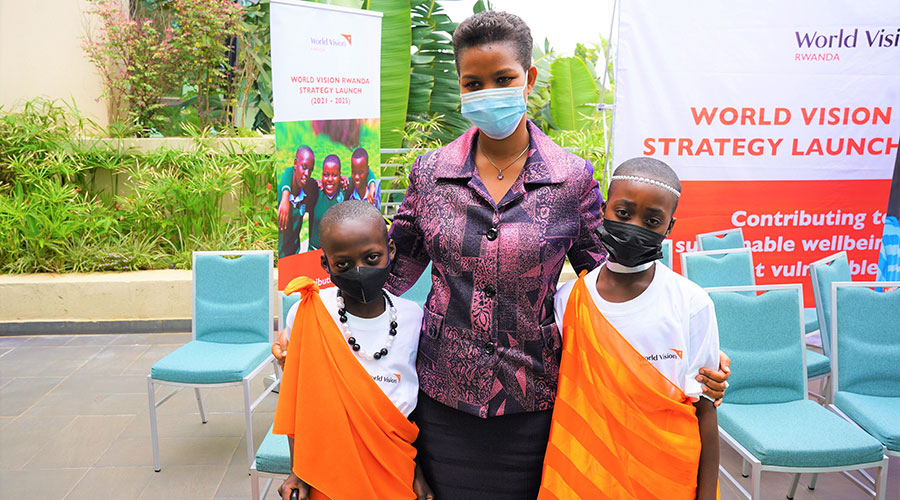 Judith Kazaire, Head of Civil Society and Political organisations Department at the Rwanda Governance Board (RGB), poses for a picture with children who shared a poem. 