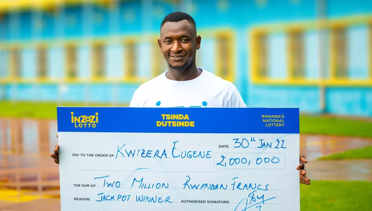 A representative of the winner of January, Eugene Kwizera with a cheque of two million Rwandan francs. 