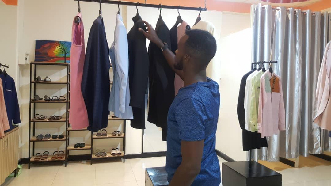 Ishimwe picks a blazer to show a customer. Photos/ Courtesy