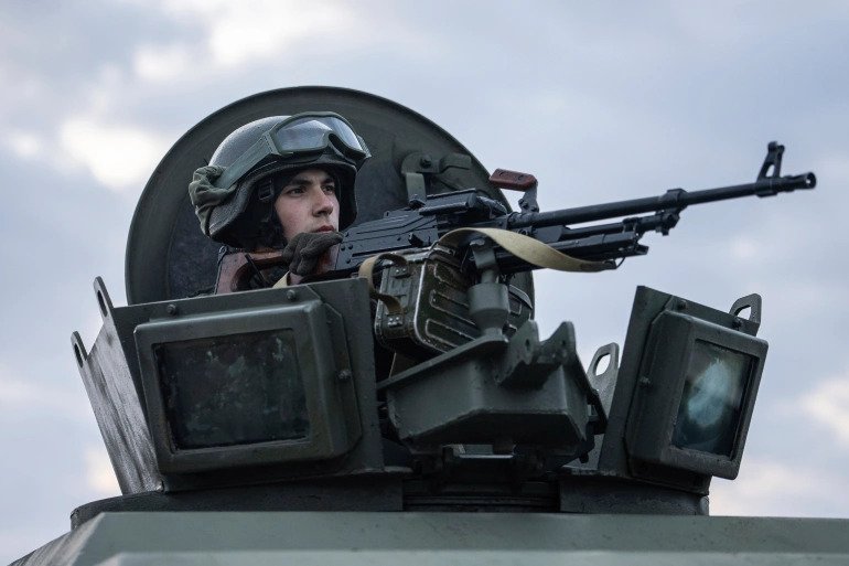 A Ukrainian national guard soldier guards a mobile checkpoint with Ukrainian security service agents and police officers during a joint operation, in Kharkiv, Ukraine, on Thursday, February 17, 2022. 