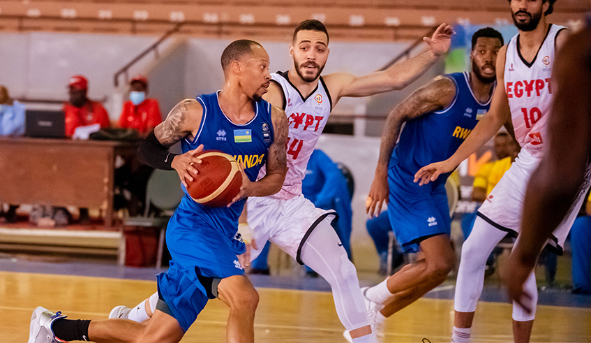 Kenny Gasana tries to go past Egyptian players during a warm up match on Tuesday in Senegal. / Courtesy