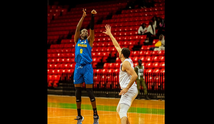 Jean Jacques Wilson Nshobozwabyosenumukiza, a point-guard shoots a throw in during the match against Tunisia on Sunday. Rwanda lost the tie. courtesy