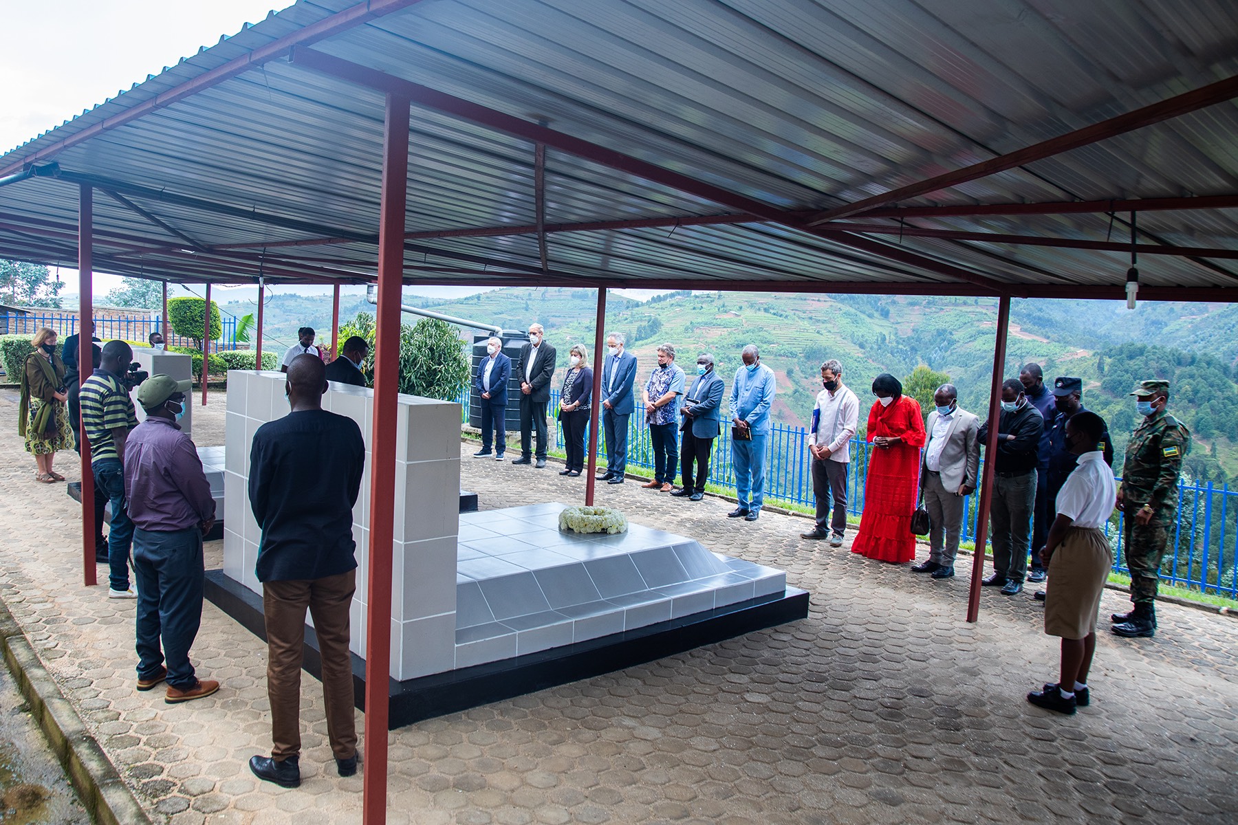 Officials oberse a moment of silence to honour victims  during a visit to Nyange Secondary School on March 7. Courtesy