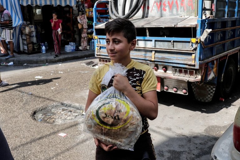 A young boy leaves a bakery with a bag of bread in the neighbourhood of Nabaa in the Lebanese capital Beirut. 