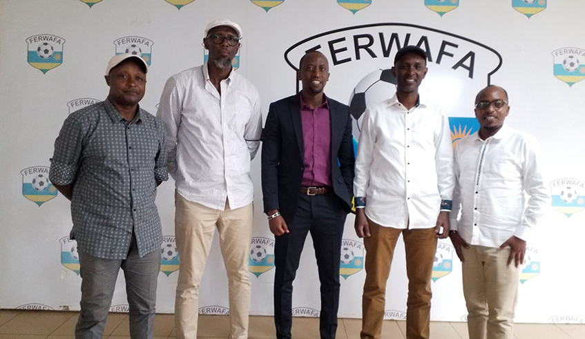 Former Amavubi players with Ferwafa President Olivier Nizeyimana (center) and Ferwafa Secretary General Henry Muhire pose for a group photo after their meeting on Wednesday. Courtesy