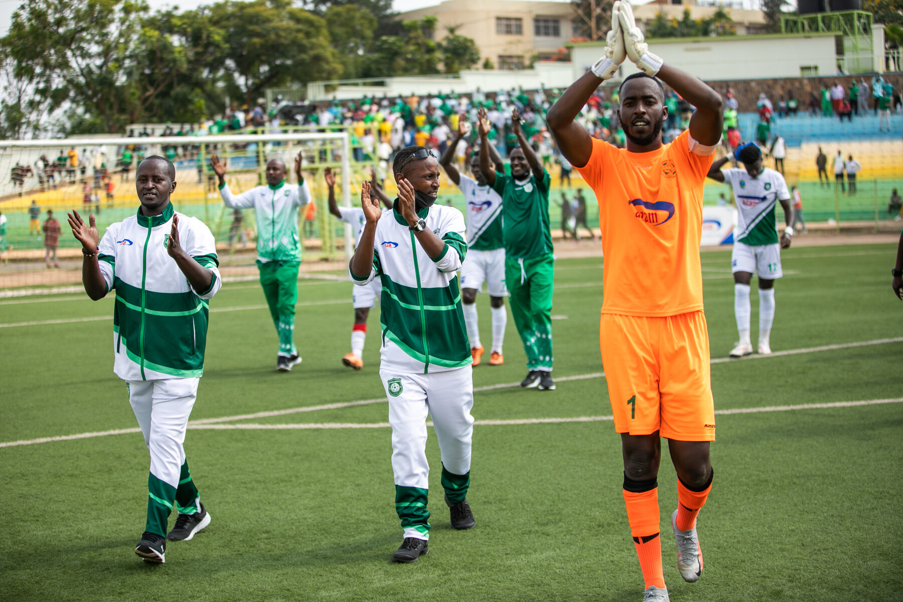 SC Kiyovu goalkeeper Yves Kimenyi and teammates thank their supporters after beating Etincelles FC 1-0 at Kigali Stadium. 