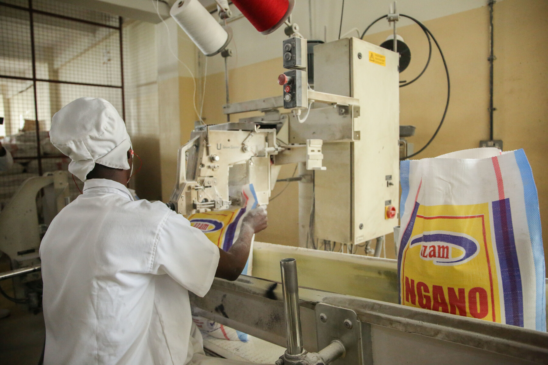 A worker seals wheat flour packages at Azam industries in Kigali October 27, 2020. Rwanda rely on Russia for wheat  imports with at least 64 per cent. 