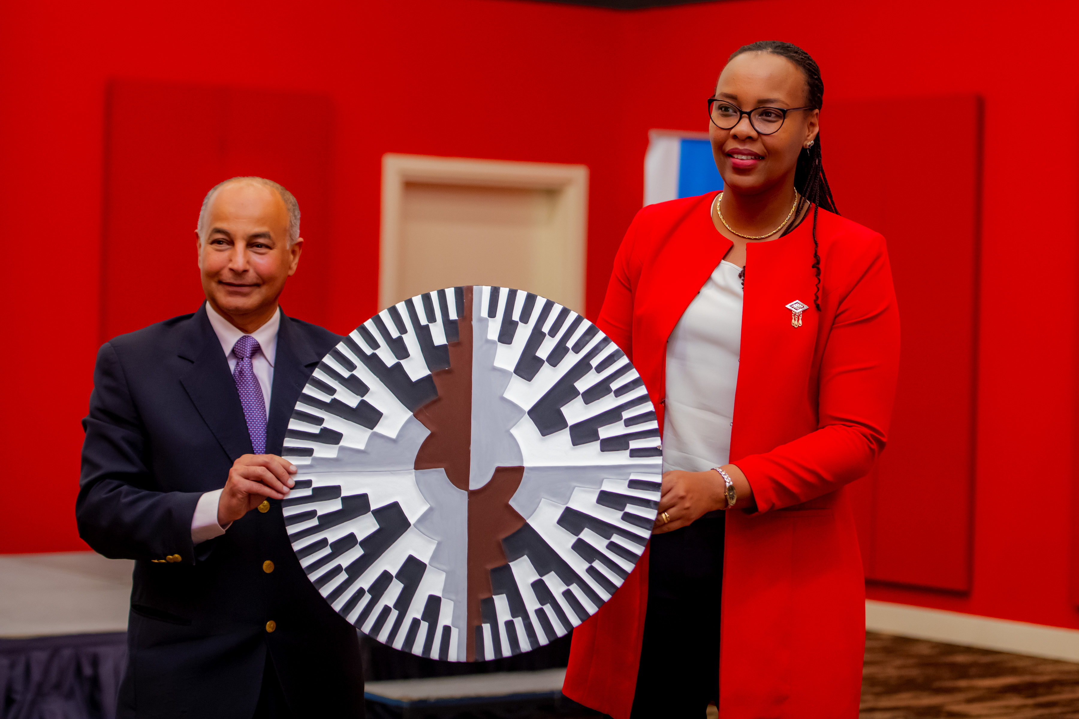 International swimming federation president Husain Al Musallam receives a gift from the Minister of Sports Aurore Mimosa during his visit last week. 