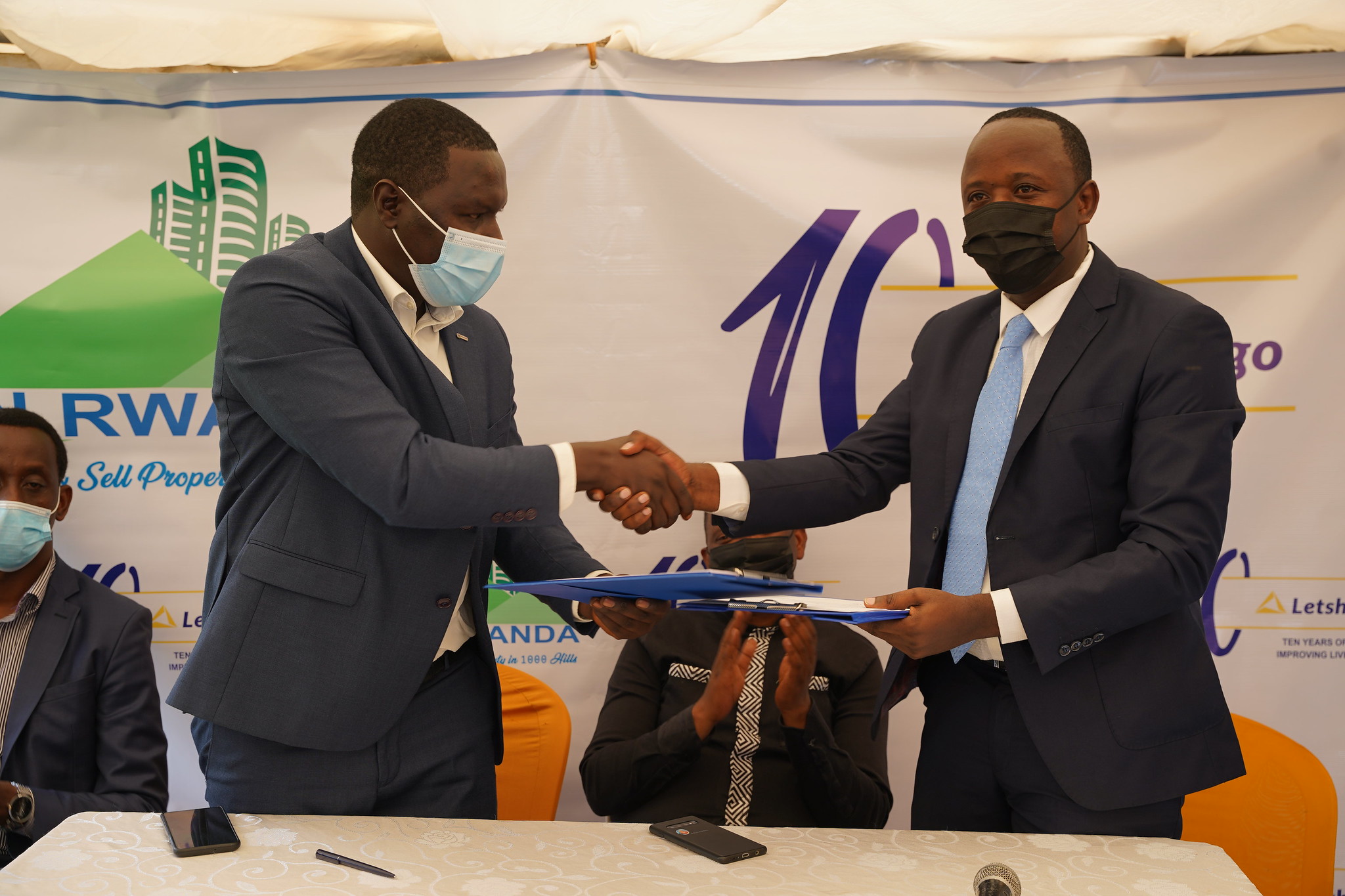 Philemon Hagenimana, Chief Executive Officer of KTN Rwanda and Gilbert Ndahimana, Head of Sales at Letshego Rwanda Plc after signing the agreement. 