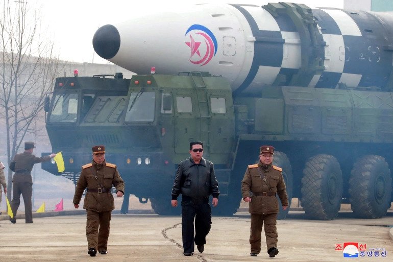 North Korean leader Kim Jong Un walks away from what state media report is a 'new type' of ICBM in this undated photo released on March 24 by North Korea's KCNA. 