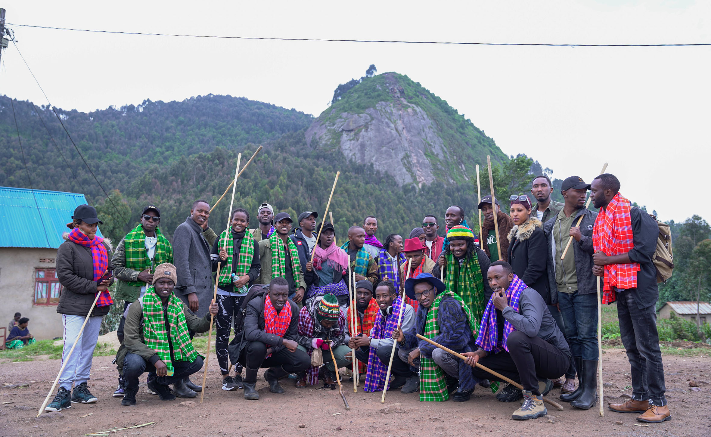 Bigogwe visitors pose for a group photo before they start hiking in Nyabihu District. Seen in the background is the famous Ibere rya Bigogwe (Bigogweu2019s breast) Mountain, which most believe is shaped like a womanu2019s breast. / Photos: Dan Nsengiyumva.