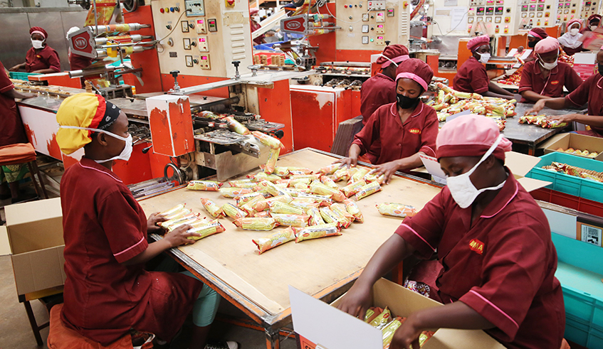 Workers package biscuits at Adma International at Kigali Special Economic Zone. The firm is one of  the factories that use wheat flour. Photo: Craish Bahizi.