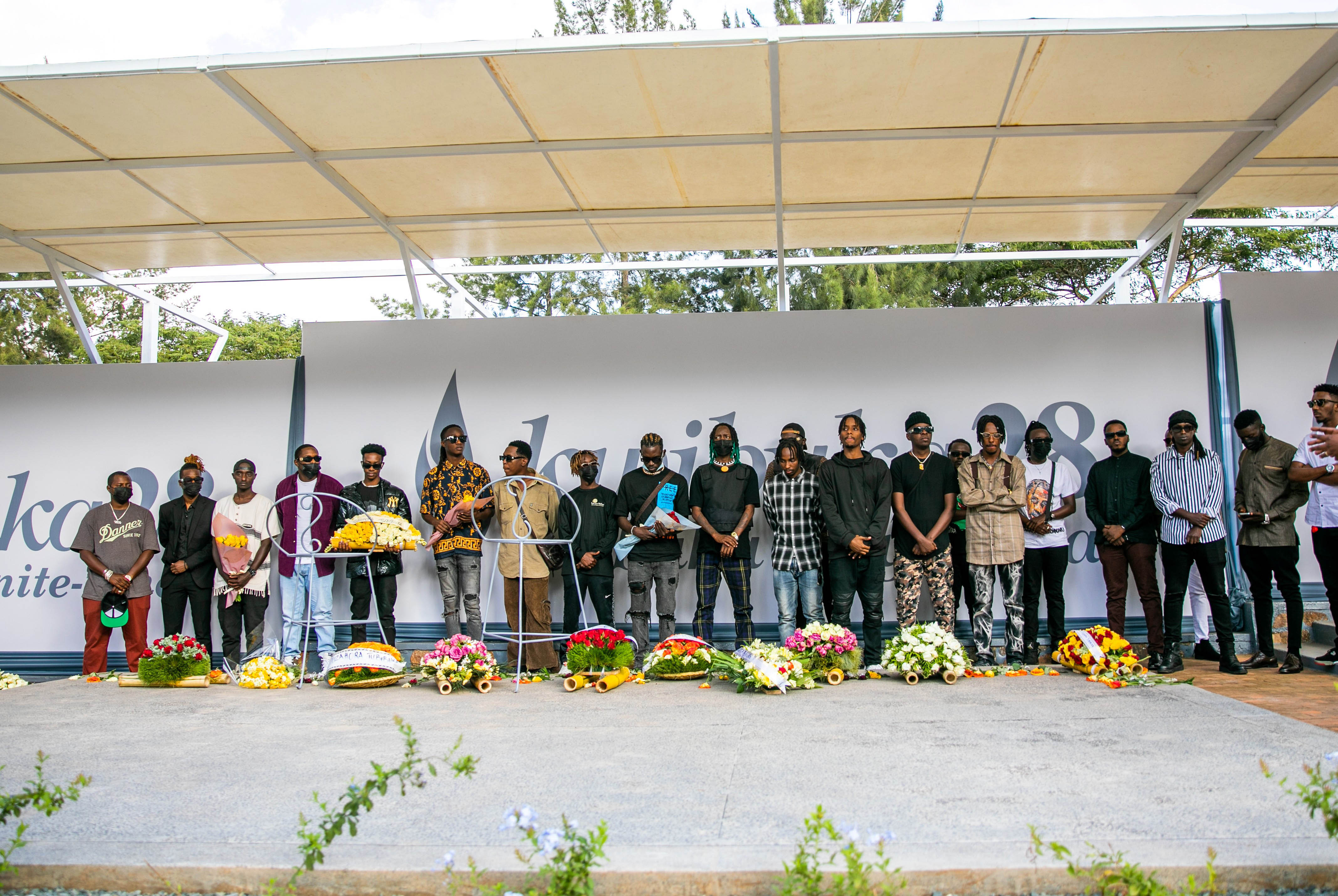 Local artistes observe a moment of silence to pay tribute to the victims of the Genocide Against the Tutsi during their visit to the Kigali Genocide Memorial . Olivier Mugwiza