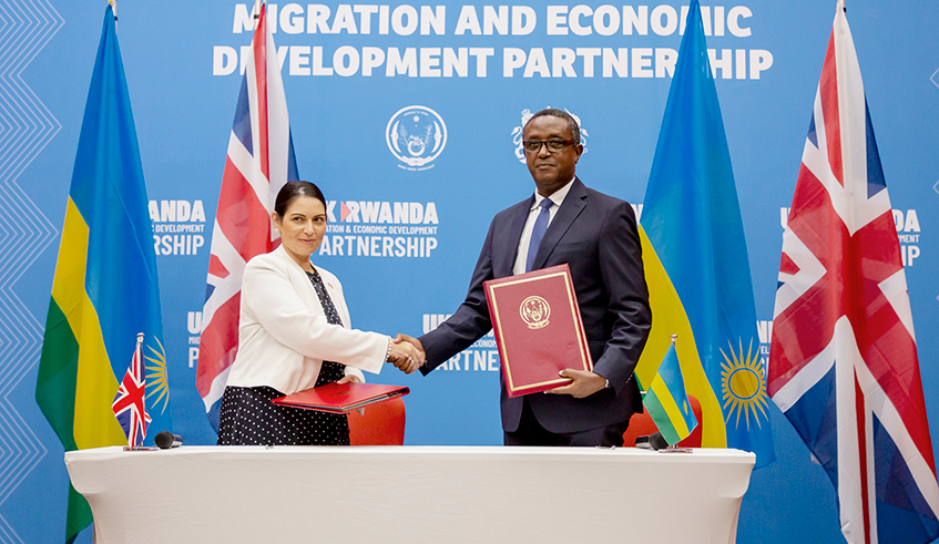 Rwandau2019s Minister for Foreign Affairs and International Cooperation Dr Vincent Biruta and the United Kingdomu2019s Home Secretary Priti Patel exchange documents after signing the five-year deal on relocation of migrants and asylum seekers in Kigali on April 14.  / Photo by Olivier Mugwiza.