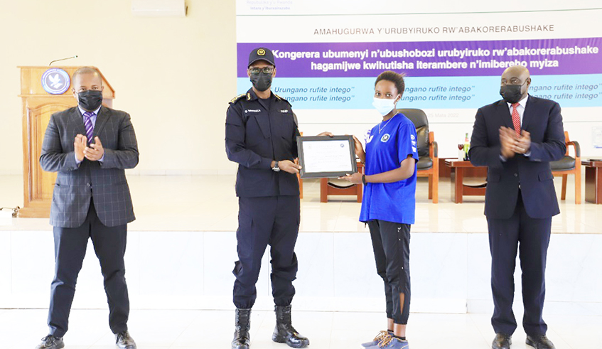IGP Dan Munyuza gives a certificate to a youth volunteer, who attended the training at Gishari in Rwamagana on Monday, April 25.Courtesy
