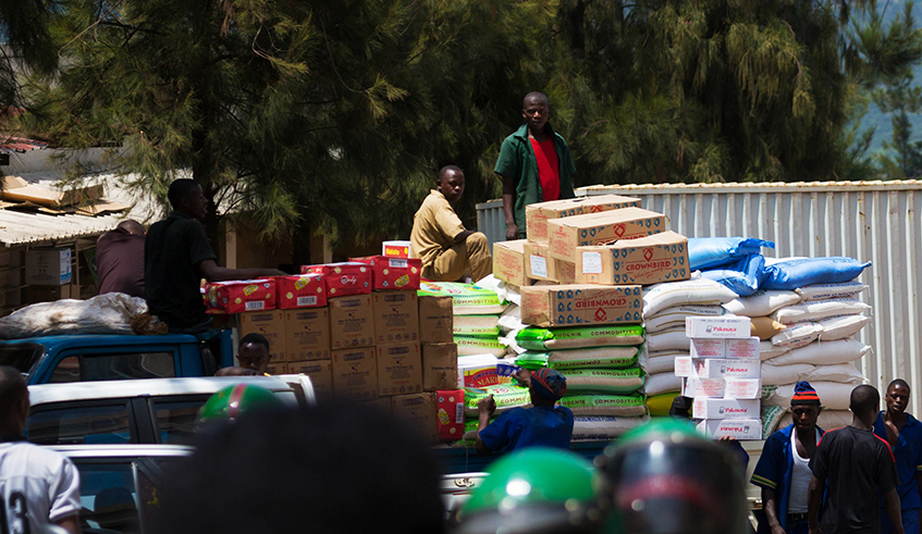 Workers load different food commodities to be transported upcountry at Kigali Business District. / Sam Ngendahimana