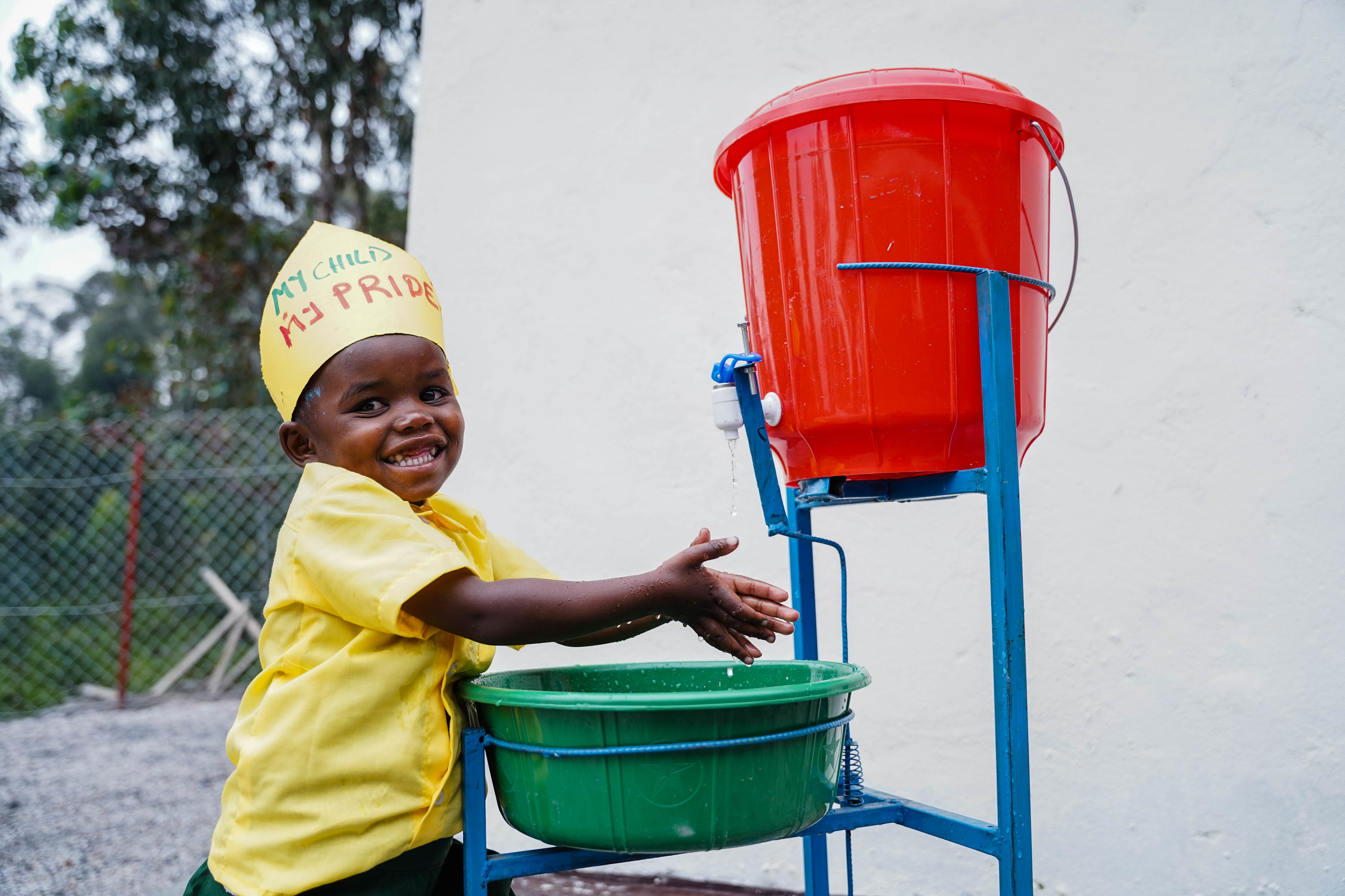 A child washes her hands at Early Children Development Center. Prioritizing hygiene among children played a big role in fighting malnutrition in Huye District. WASH facilities have improved the health status of children. / Dan 