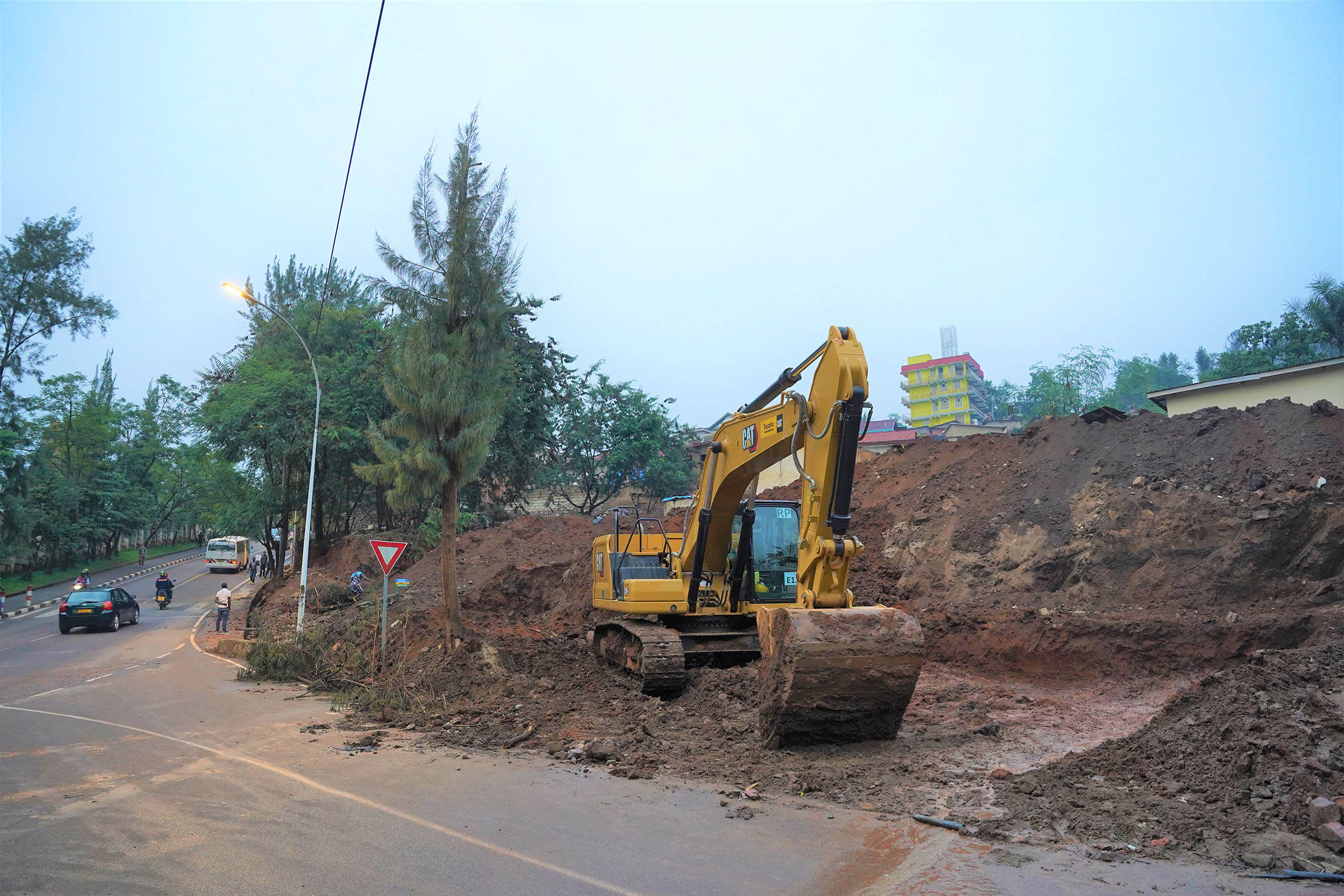 An excavator during works on Kacyiru-Kimicanga road, one of the side roads being upgraded as the capital Kigali gears up for the 26th edition of the Commonwealth Heads of Government Meeting (CHOGM) due next month. Officials have urged motorists to familiarise themselves with new side roads around the city since some of the main roads will be blocked during the weeklong summit. / Photo: File. 