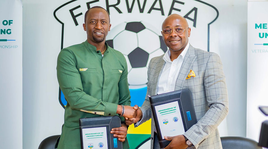 Ferwafa boss Olivier Nizeyimana (L) and his FIFVE counterpart Fred Siewe after signing the memorandum of understanding to collaborate in organising the veterans world cup. 