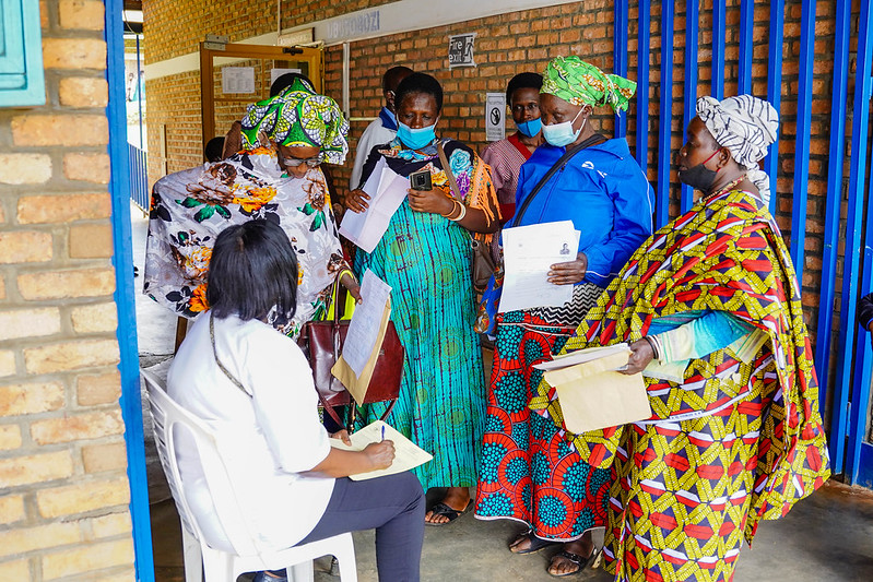 A member of the Medical Volunteers Organisation helps the patients to arrange their medical documents before the consultation room to meet with the specialists at Nyamata health center. 