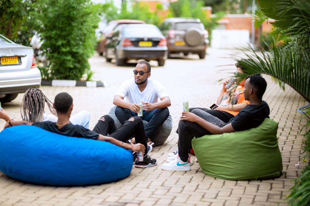 A group of people relax in the duou2019s locally made bean bags. Photos/Courtesy