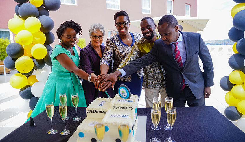 Minister of Trade and industries Beata Habyarimana with other officials cut cake during the celebration of 10 years anniversary of BPN Rwanda  on May 11, 2022. Dan Nsengiyumva