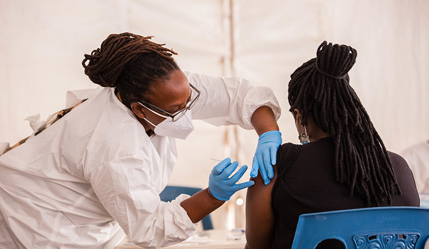 A health worker conducts the Covid 19 vaccination activity in Kigali on August 3, 2021. Dan Nsengiyumva