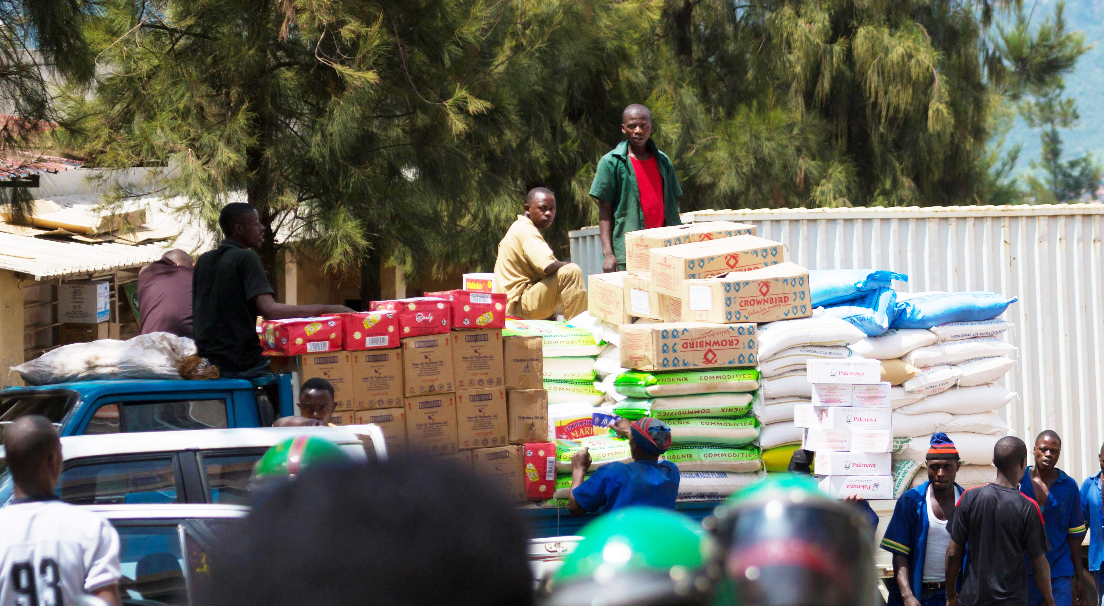 Workers load different food commodities to be transported upcountry at Kigali Business District. 