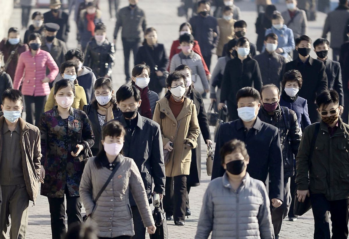 People wearing protective face masks commute amid concerns over the new coronavirus disease (COVID-19) in Pyongyang, North Korea March 30, 2020, in this photo released by Kyodo. 