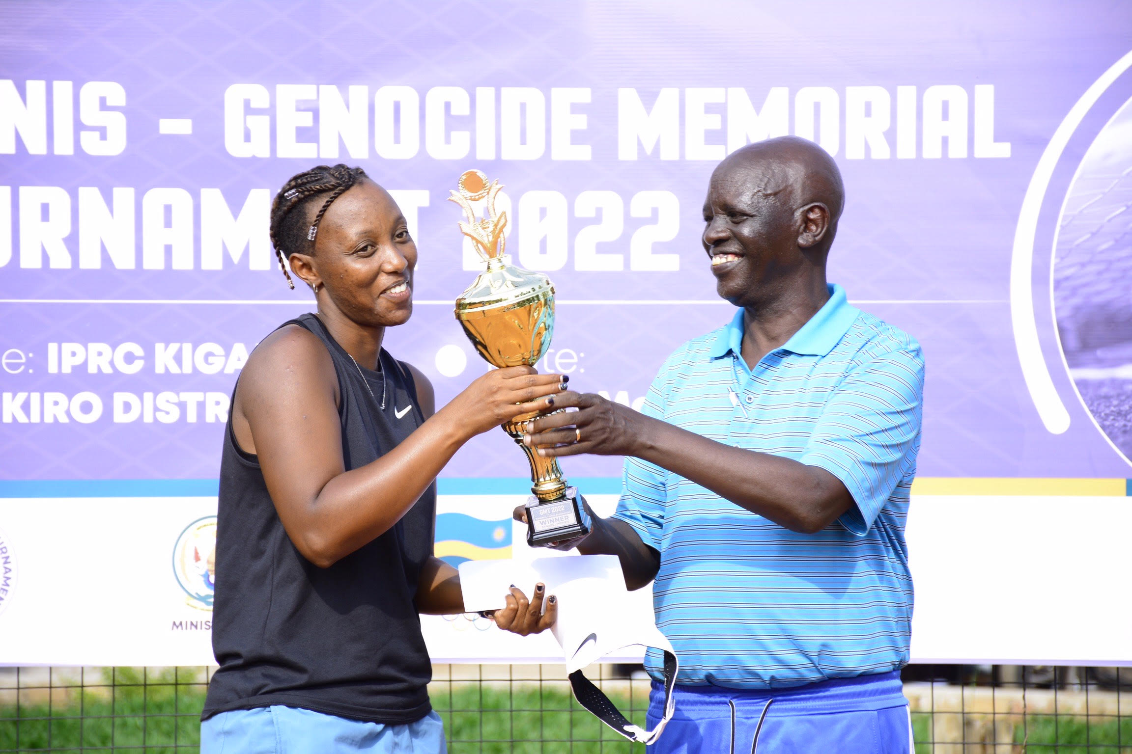 Joselyne Umulisa receives the Women singles trophy from Theoneste Karenzi, the president of Rwanda Tennis Federation on Sunday, May 15. 