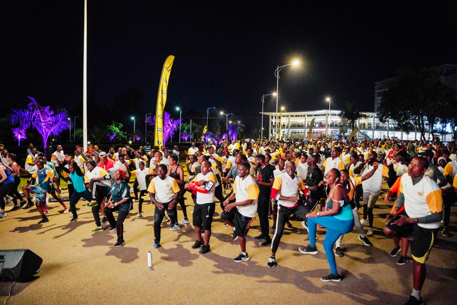 Kigalians stretching their bodies matching their moves with the beat of the music during Kigali Night Run on Friday. 