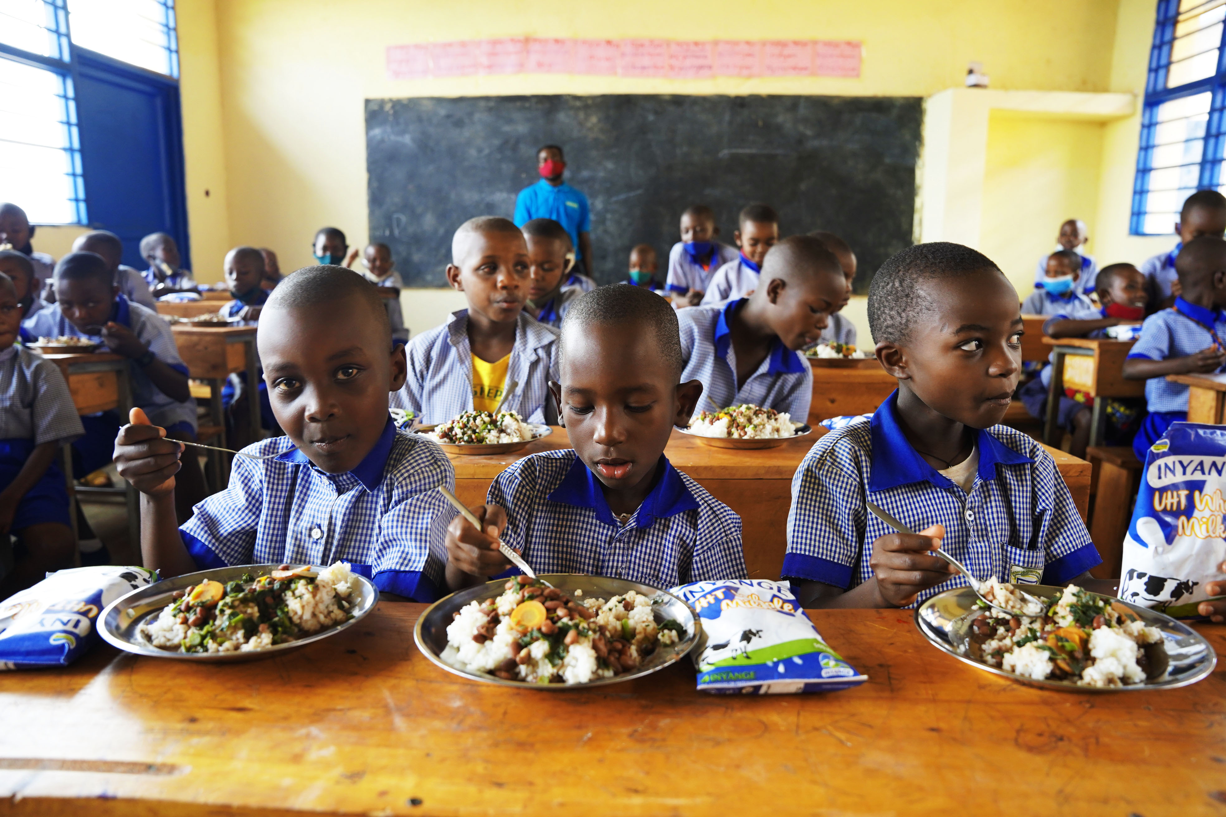 Children have lunch through school feeding program at Masaka Primary School in Kicukiro District on February 28, 2022. According to the statistics the project served meals to about 808,000 children in 979 schools through school feeding programme for initial three months on school reopening. 